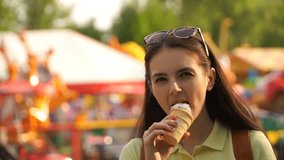 Caucasian woman walking in the park and eating ice cream. HD video