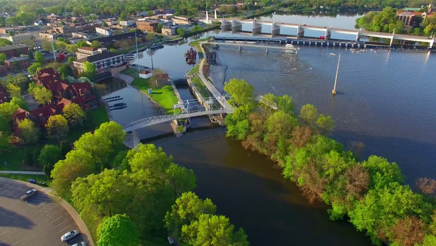 Beautiful morning aerial flyover of De Pere Wisconsin waterfront area, Voyager Park, Fox River, bridge, lock.