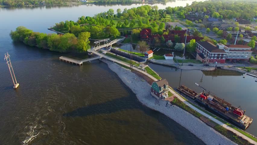 Beautiful morning aerial flyover of De Pere Wisconsin waterfront area, Voyager Park, Fox River, bridge, lock.