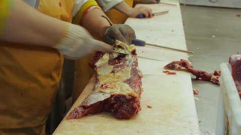 pork meat beef carcass hanging in a meat factory producing sausages butcher cuts a fresh raw meat to make sausage sausages steaks sharp knife cut the meat knife man many meat production process
