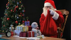 Santa putting wrapped presents into his sack