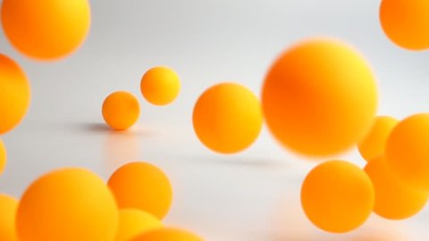 many orange balls falling and bouncing over the white surface slow motion