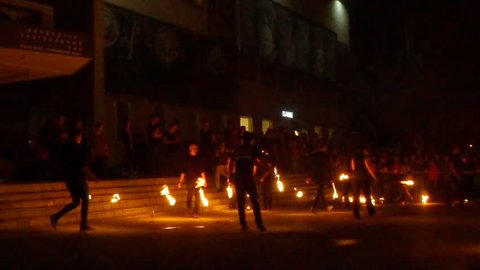 NOVOSIBIRSK, RUSSIA - APRIL 30, 2016: Fire show with fire dancers. Young man firebreathing - slow motion.