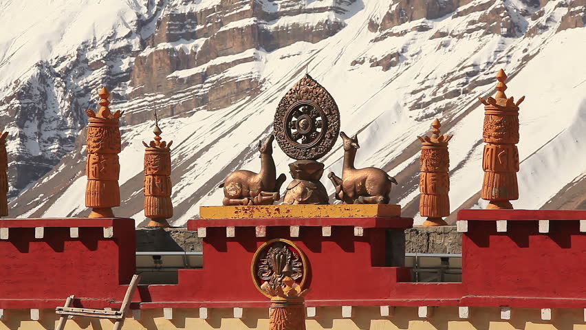 Buddhism symbols: figures of deers and Dharma Wheel on a background of snowy mountains. Dhankar Gompa Monastery, Spiti valley, Himachal Pradesh, India. 
Canon 5D MkII.