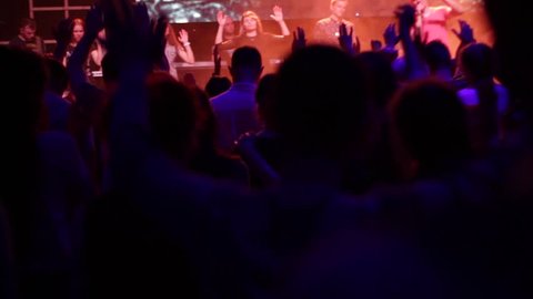 Lot of people clapping at rave party. Here is footage of people crowd partying at a concert or a night club. worship