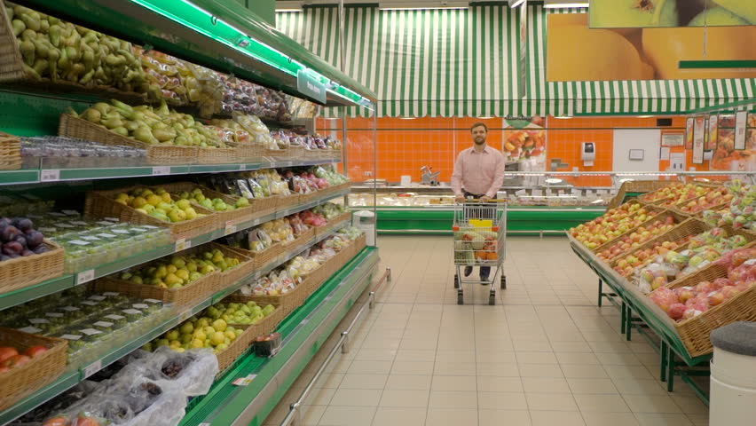 Man pushing shopping trolley in store