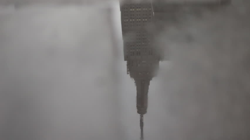 New York, USA - April 05, 2015: Empire State Building reflected in rain puddle, New York City, New York, USA