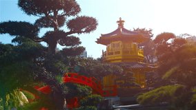 Ornamental pagoda and bridge are centerpieces in the decorative. manicured gardens of Chi Lin Nunnery in Hong Kong. China. Video FullHD