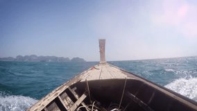 Wooden longtail boat. cruising at high speed over rough water off tropical Thailand. bouncing and splashing over the waves. with sound. Video FullHD