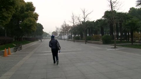 Travel girl walk on Shanghai empty streets, long shoot