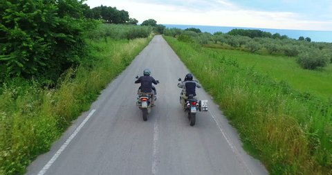 italy, hills of tuscany, camera car of Two motorcyclists on mountain highway having fun and enjoying road, no logos shot NO LOGOS