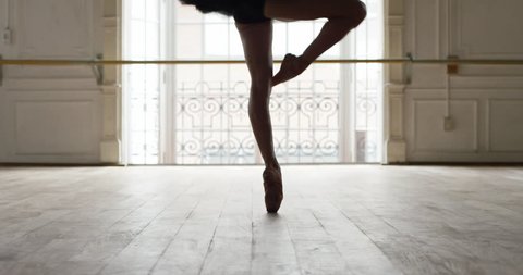 Buenos Aires, Argentina - February 27, 2015: Ballerina performing pirouettes in studio, slow motion