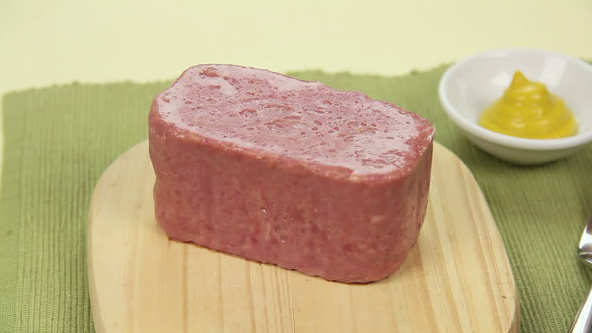 Spam being sliced into slices with a kitchen knife. Royalty-Free Stock Footage #1690354