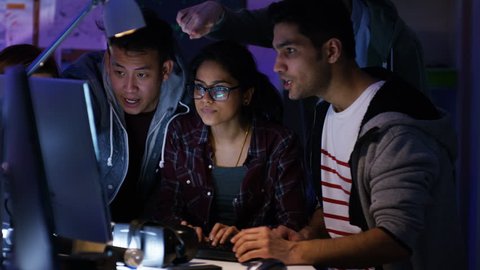 4K Team of young computer hackers trying to gain access to a computer system. Shot on RED Epic. UK - April, 2016