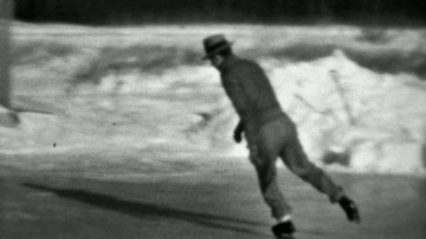MINNEAPOLIS, MINNESOTA ? 1937: Man ice skating backwards winter flooded backyard rink.