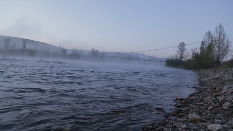 the dawn on the river with fog at summer