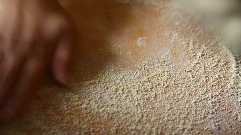 Kneading dough for pita bread on wooden board