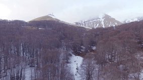 The camera overlooks a snowy forest on the mountains. Aerial drone video. N.
Videos about mountains, mountainous, snow, winter, christmas