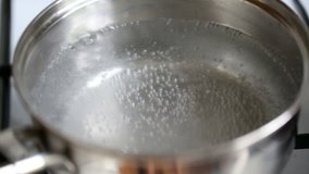 Water boils in a pot. Static video full hd.