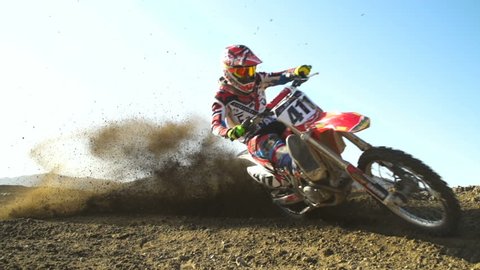 Super Slow Motion Professional Motocross Rider On Dirt Track.
