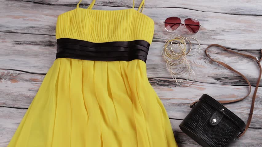 black dress with yellow accessories