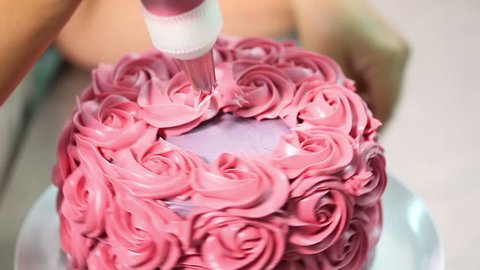 confectioner decorates cakes on Valentine day 