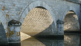Ancient stone bridge reflection in river surface 4K 2160p 30fps UltraHD footage - Sun shine and bridge reflecting on water 4K 3840X2160 UHD video