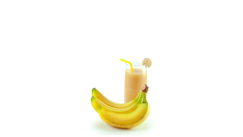 Healthy vegan smoothie with Vitamins fly out of the glass of banana smoothie and a bunch of bananas Royalty-Free Stock Footage #16959595