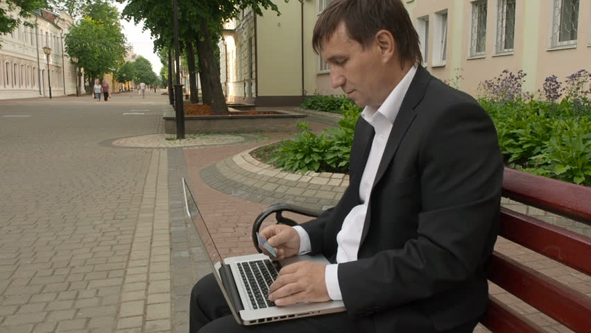 Businessman using his laptop to purchase something online with his credit card