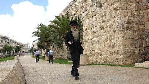 Walking bearded old jewish man - September 2015: Jerusalem old city wall, Israel,