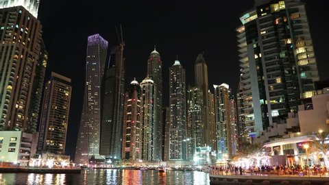 8K Dubai Marina night time lapse, UAE. Dubai Marina - the largest man-made marina in the world, is a canal city, carved along a 3 km stretch of Persian Gulf shoreline. Dubai 8K 7680x4320 Timelapse