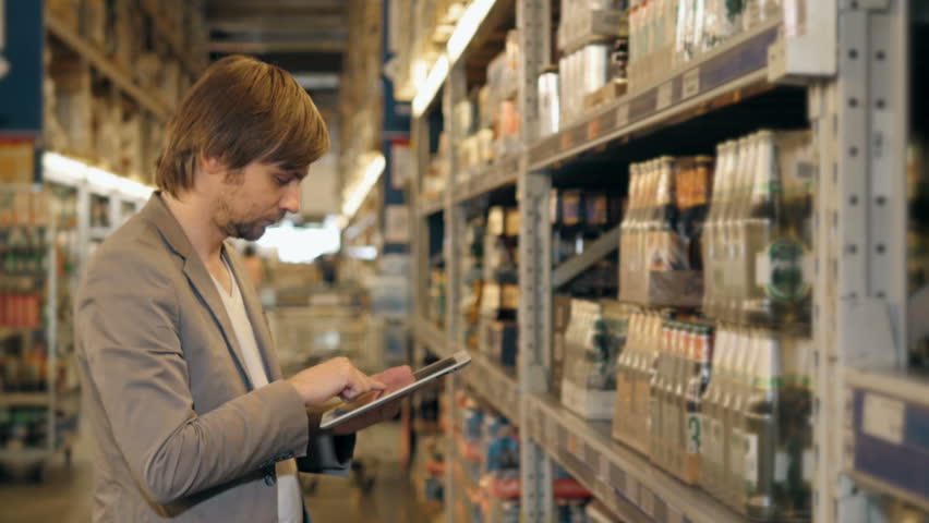Manager With Tablet PC Checking Goods At Supermarket Warehouse | Shutterstock HD Video #16968079
