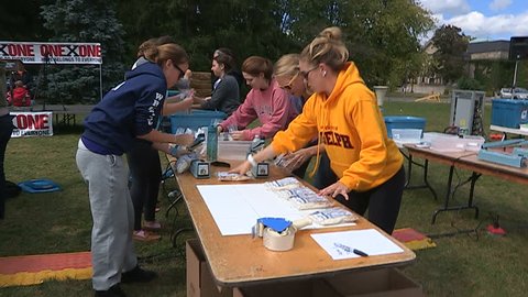 Guelph, Ontario, Canada September 2014 Students Volunteers pack charity food aid for homeless and starving in Africa
