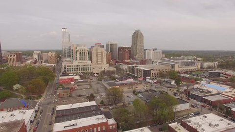 Rising aerial footage approaching downtown Raleigh, NC.