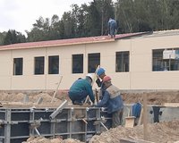 Workers concrete foundations and roof house. Construction industry. 