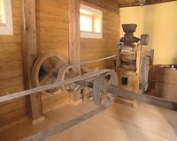 Old mill equipment. Human hands turn machines. Grain milling technology. 