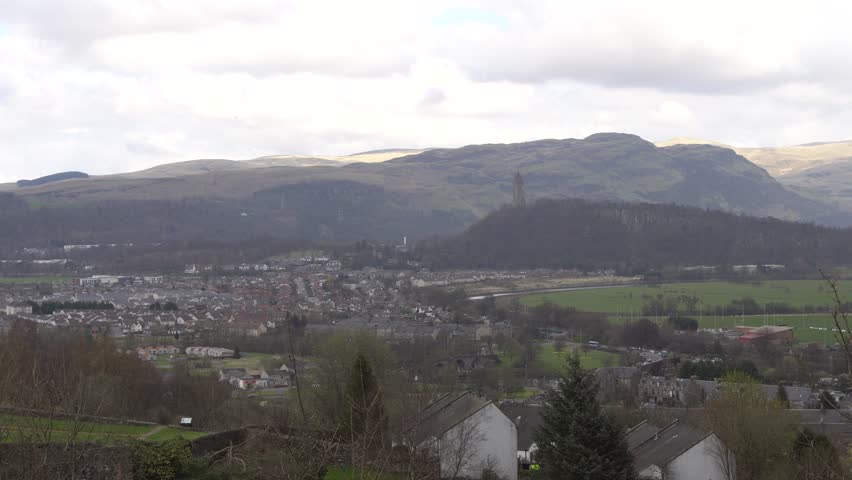 Aerial view of city of Stirling and The Wallace Monument (The National Wallace Monument) on the summit of Abbey Craig hill, Stirling, Scotland. Seen from Stirling Castle.
