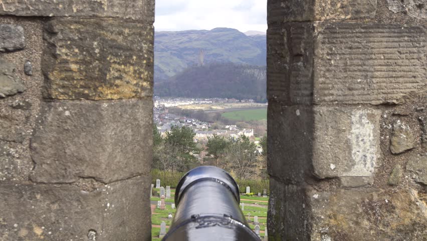 The Wallace Monument (The National Wallace Monument) on the summit of Abbey Craig hill, Stirling, Scotland. Seen through the outer defence wall of Stirling Castle, Scotland, UK