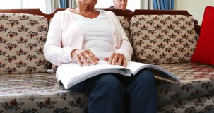 Senior Caucasian woman reading book in braille in retired house