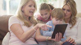 4K 3 Generations of happy family making video call on tablet computer UK - April, 2016