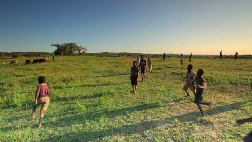 KENYA, AFRICA - CIRCA AUGUST 2010: Children playing soccer outside in a village