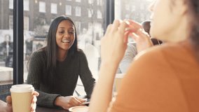 4K Happy group of friends chatting & using technology in city coffee shop UK - April, 2016 - Powered by Shutterstock - Get 15% off with code: PIKWIZARD15