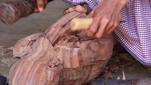 Burmese man are making wooden souvenirs for tourists in Bagan, Myanmar. Wood Carving is a traditional handicraft in Myanmar, Burma