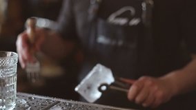 Bartender mannually crushed ice with wooden metal knife. - Powered by Shutterstock - Get 15% off with code: PIKWIZARD15