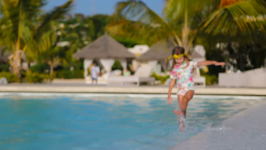 Little adorable girl in outdoor swimming pool