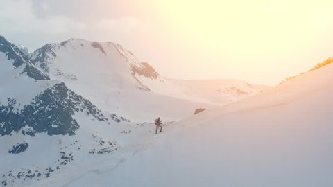 Drone Footage Man Climbing Snowcapped Mountain Adventure Alps Majestic Courage Exploration Hiking Vacation Snow Tranquility Nature Travel Recreation White Cold Aerial Agility Mountaineering