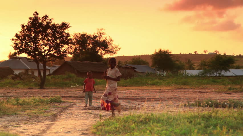 KENYA, AFRICA - CIRCA AUGUST 2010: Children looking at the camera at sunset in