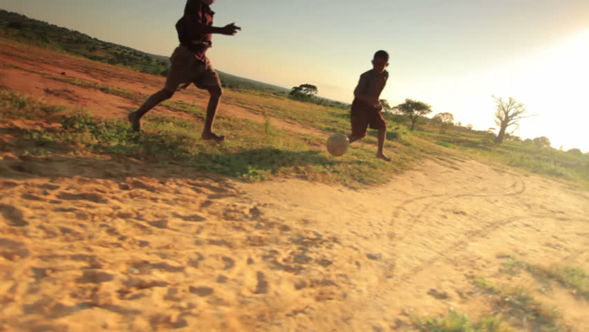 KENYA, AFRICA - CIRCA AUGUST 2010: Children playing soccer on the fields in