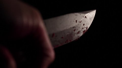 Close up of bloody knife, murder