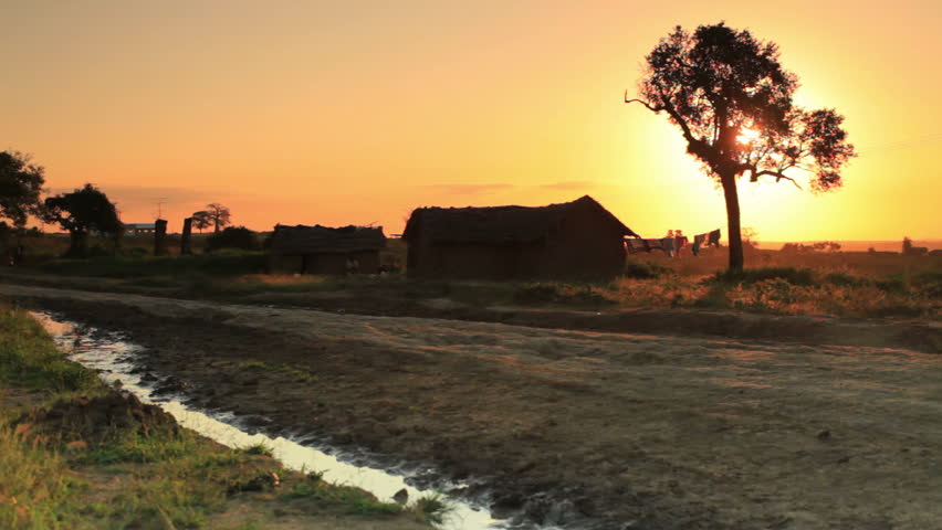 Shot of a dirt road and homes at sunset in Kenya, Africa.